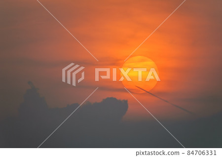 Sun disk through the clouds at sunset above the horizon. France. Sun disk through the clouds at sunset above the horizon. France. 84706331