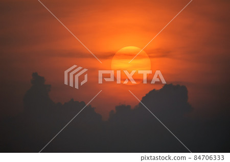 Sun disk through the clouds at sunset above the horizon. France. Sun disk through the clouds at sunset above the horizon. France. 84706333