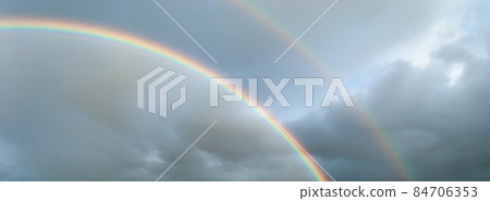 Double rainbow in a stormy sky in the evening.. France, Europe. Double rainbow in a stormy sky in the evening.. France, Europe. 84706353