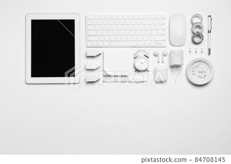 Flat lay composition with tablet and different office items on white background Flat lay composition with tablet and different office items on white background 84708145