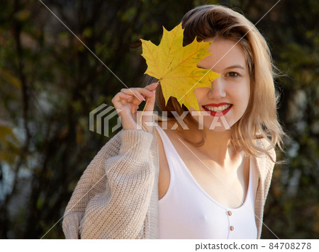 Excited happy fall woman smiling joyful and Excited happy fall woman smiling joyful and 84708278