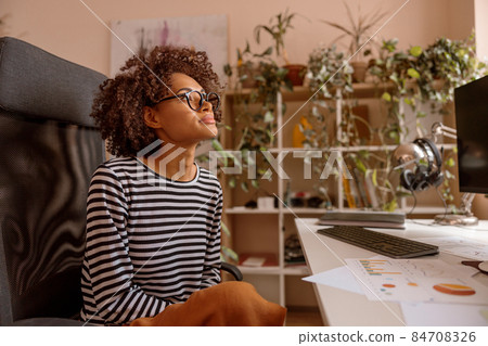 Multiracial young woman is working at home Multiracial young woman is working at home 84708326