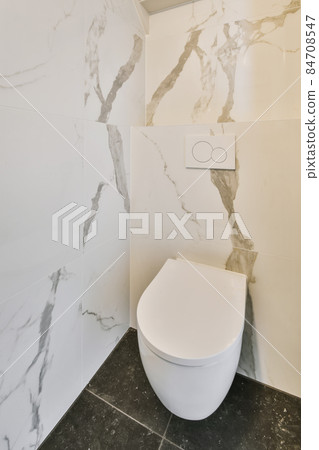 Small restroom with marble walls and floor 84708547