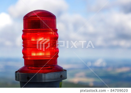 Red warning lights for air traffic on roof of high building, airport lighting equipment, daylight Red warning lights for air traffic on roof of high building, airport lighting equipment, daylight 84709020