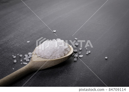 Wooden spoon with sea salt on a chalk board 84709114