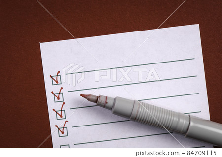Check List. Sticky note and red pen 84709115