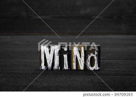 MIND. Education, skills, health and stress concept. Dark wood texture background 84709163