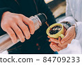 boy pours hot cacao to his girlfriend's green cup. winter theme 84709233