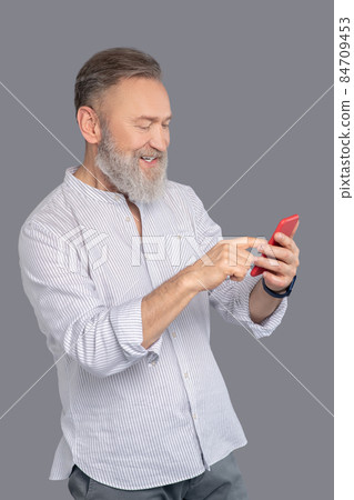 Mature man with a smartphone in hands 84709453