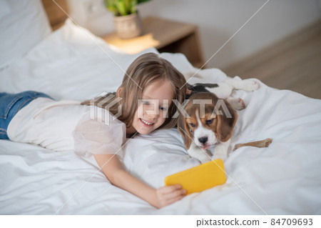 Female child taking selfies with her dog Female child taking selfies with her dog 84709693