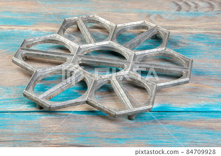 Old aluminum dumplings mold on blue wooden background. Old aluminum dumplings mold on blue wooden background. 84709928