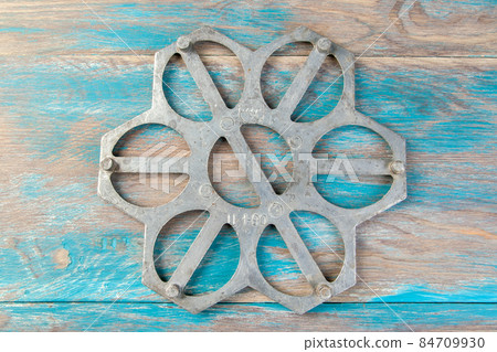 Old aluminum dumplings mold on blue wooden background. Old aluminum dumplings mold on blue wooden background. 84709930