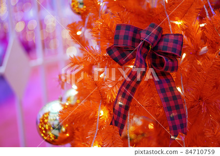 Ribbon on red fake christmas tree. Ribbon on red fake christmas tree. 84710759