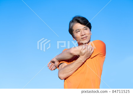 Upper body of a middle-aged man stretching 84711525