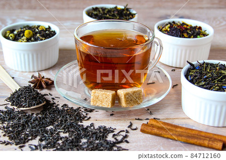 Tea assortment. Various kinds of tea. Prepared tea in a cup with sugar Tea assortment. Various kinds of tea. Prepared tea in a cup with sugar 84712160
