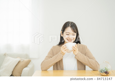 Japanese woman drinking hot soup at home 84713147
