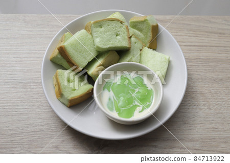 bread steamed custard in a white plate on a wooden table bread steamed custard in a white plate on a wooden table 84713922
