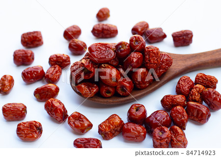 Dried Chinese jujubes on white background. 84714923