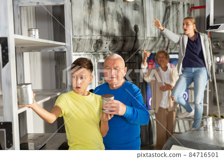 Grandson together with his grandfather solve the riddles of quest room 84716501