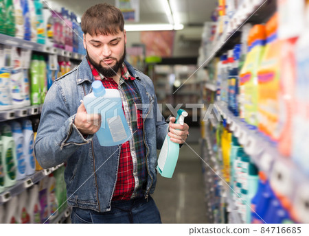 Ordinary young man making purchases in store 84716685