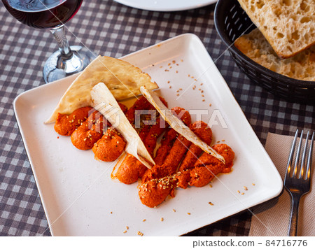Spicy Muhammara dip from Aleppo pepper and walnuts with flatbread Spicy Muhammara dip from Aleppo pepper and walnuts with flatbread 84716776