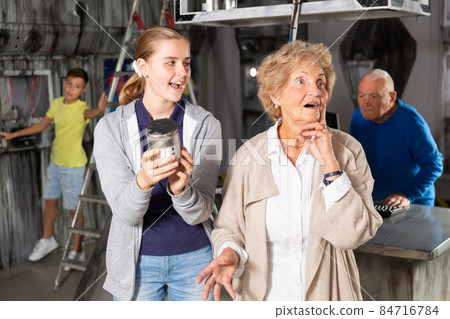 Kids and grandparents solving conundrum in quest room 84716784