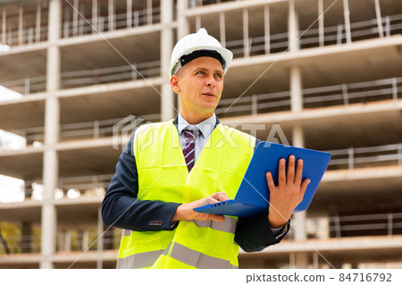Young focused engineer controlling the progress of work on a laptop 84716792