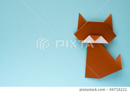 Brown origami cat on light blue background Brown origami cat on light blue background 84718222