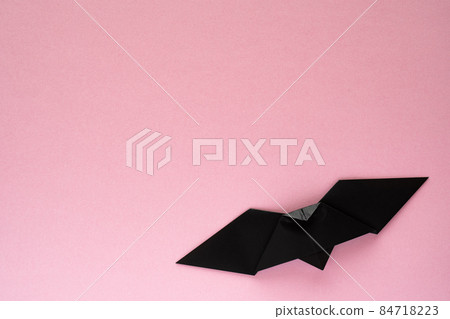 Black origami bat on pink background Black origami bat on pink background 84718223
