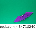 Purple origami bat on green background 84718240