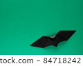 Black origami bat on green background 84718242