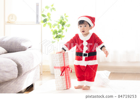 Boy in Santa's costume Boy in Santa's costume 84719253