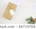 Vintage craft gift with rope and blank label isolated on white background. Top view, copy space 84719768