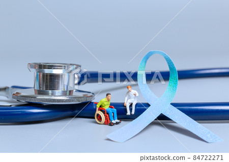Man sitting on wheelchair and doctor with ribbons , World cancer day concept Man sitting on wheelchair and doctor with ribbons , World cancer day concept 84722271