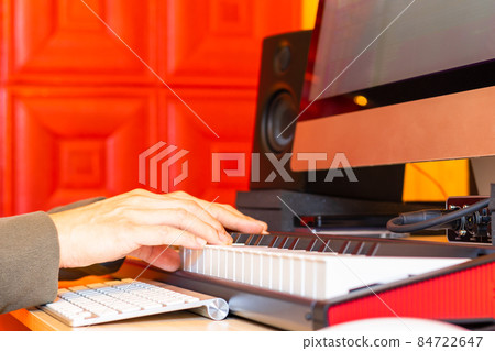 close up male musician hands playing midi keyboard for recording on desktop computer. music production concept background close up male musician hands playing midi keyboard for recording on desktop computer. music production concept background 84722647