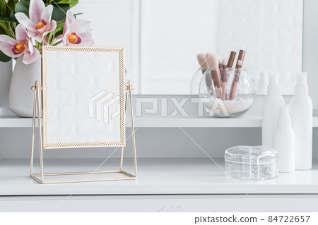 Table mirror on dressing table with make up accessories. Self-Care. White, pastel interior Table mirror on dressing table with make up accessories. Self-Care. White, pastel interior 84722657
