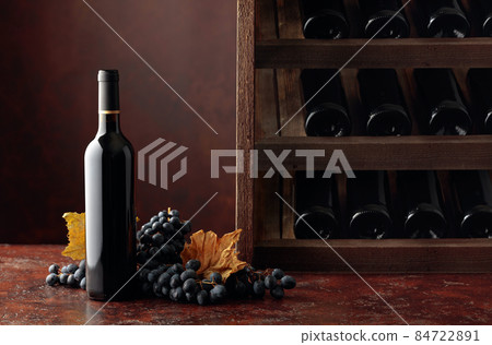 Red wine and grapes in wine cellar. Red wine and grapes in wine cellar. 84722891