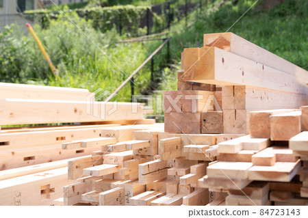 Lumbers piled up at the construction site 84723143