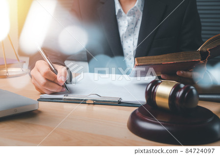 Male judge working with contract papers on white wooden table in courtroom. Laptop computer, legal books and gavel on white desk. justice and law concept. Male judge working with contract papers on white wooden table in courtroom. Laptop computer, legal books and gavel on white desk. justice and law concept. 84724097