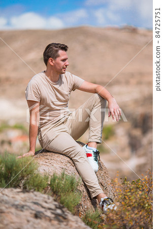 Tourist man outdoor on edge of cliff seashore 84725751