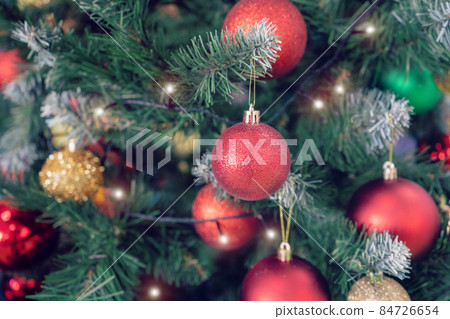 Closeup of red bauble hanging from Christmas tree. New Year concept 84726654