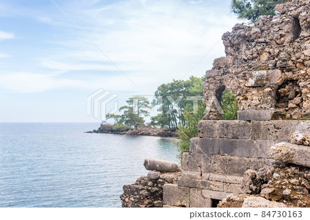 Mediterranean landscape with ancient dilapidated builing on the seashore 84730163