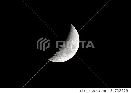 Partial moon against a black sky 84732579