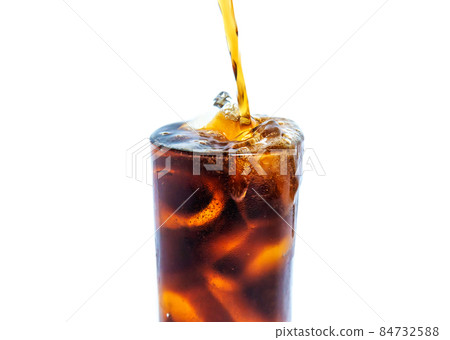 Solt drink being poures into a glass with ice Solt drink being poures into a glass with ice 84732588