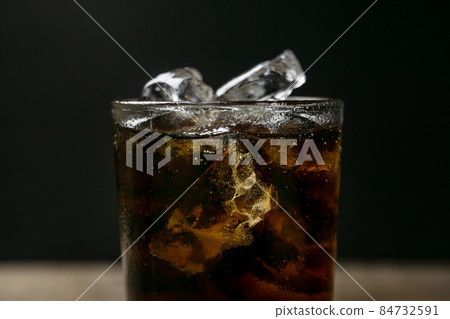 Solt drink being poures into a glass with ice Solt drink being poures into a glass with ice 84732591