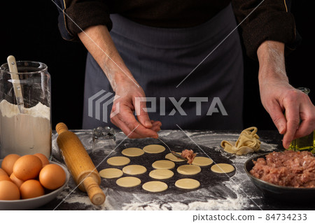 Process of preparing a traditional Russian dish dumplings 84734233