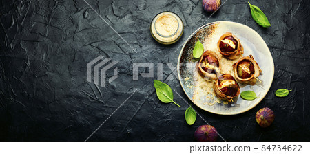 Figs roasted in bacon with cheese,space for text 84734622