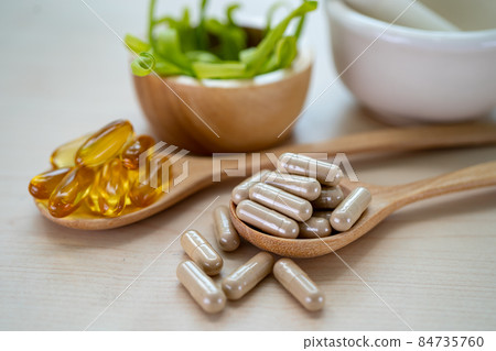 Alternative medicine herbal organic capsule with vitamin E omega 3 fish oil, mineral, drug with herbs leaf natural supplements for healthy good life. Alternative medicine herbal organic capsule with vitamin E omega 3 fish oil, mineral, drug with herbs leaf natural supplements for healthy good life. 84735760