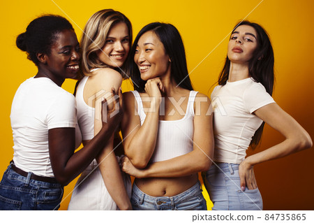 diverse multi nation girls group, teenage friends company cheerful having fun, happy smiling, cute posing on yellow background, lifestyle people concept, african-american, asian and caucasian diverse multi nation girls group, teenage friends company cheerful having fun, happy smiling, cute posing on yellow background, lifestyle people concept, african-american, asian and caucasian 84735865