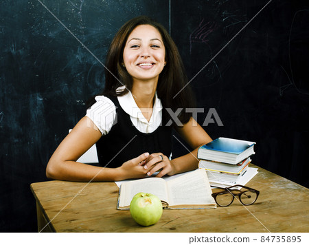portrait of happy cute real teen student in classroom at blackboard, lifestyle people concept portrait of happy cute real teen student in classroom at blackboard, lifestyle people concept 84735895